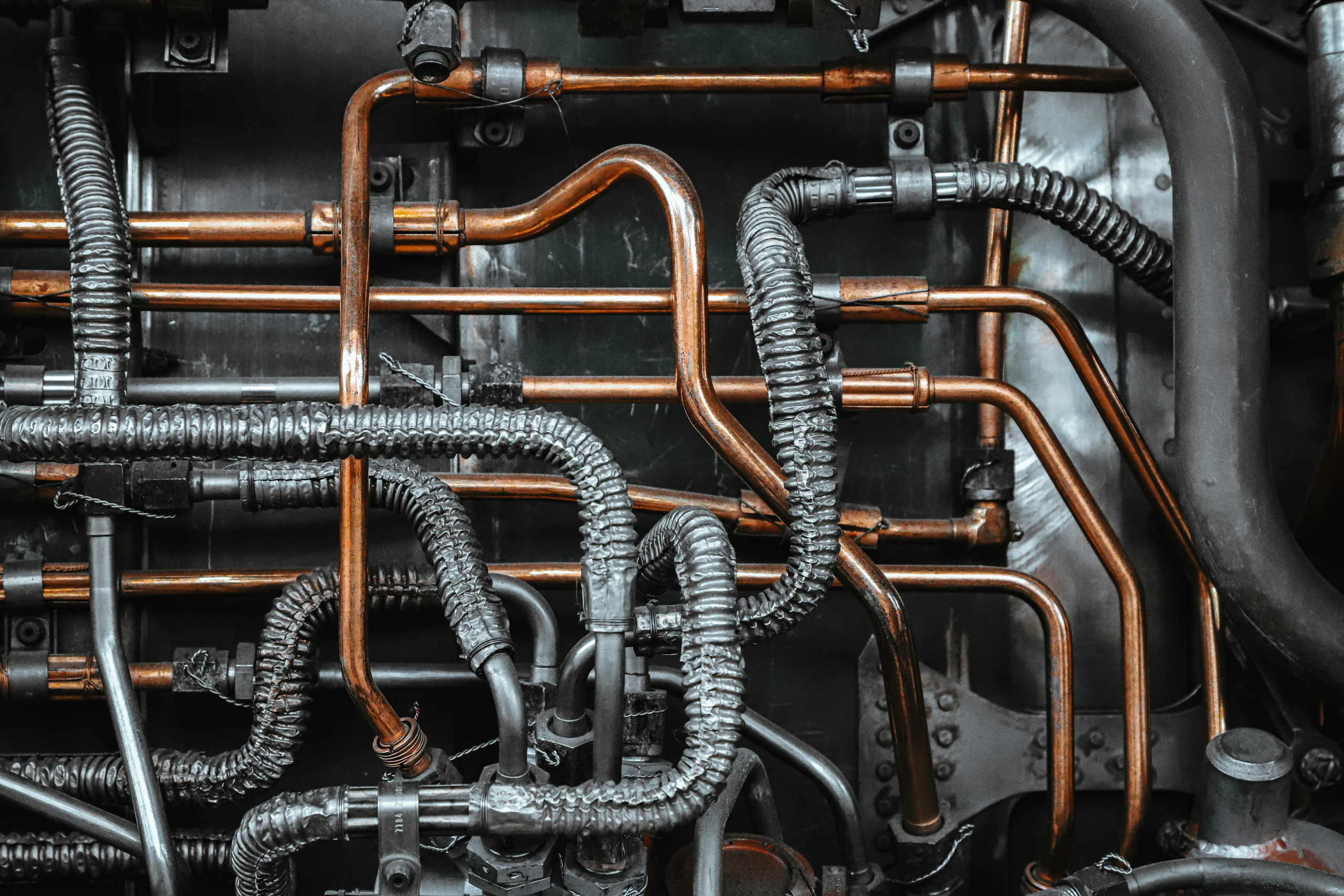 Close-up of copper refrigerant piping and coils inside a commercial HVAC unit