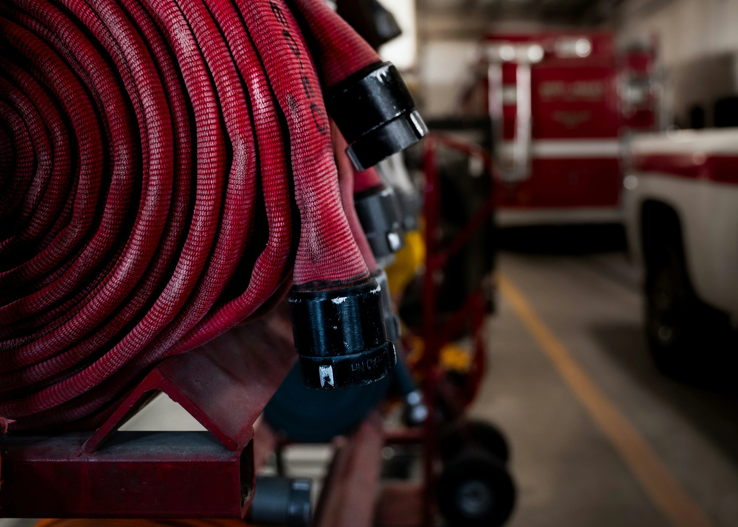 Coiled fire hose and fittings as part of a commercial fire suppression and life-safety system