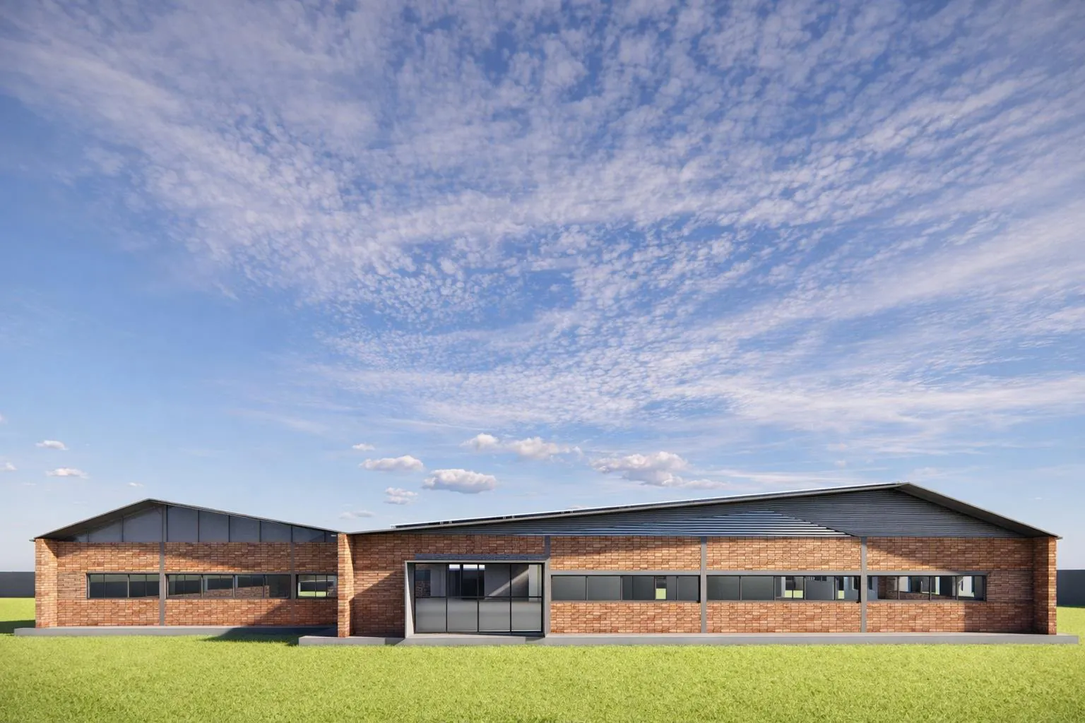 Industrial canteen building in brick with a metal roof and a glazed entrance