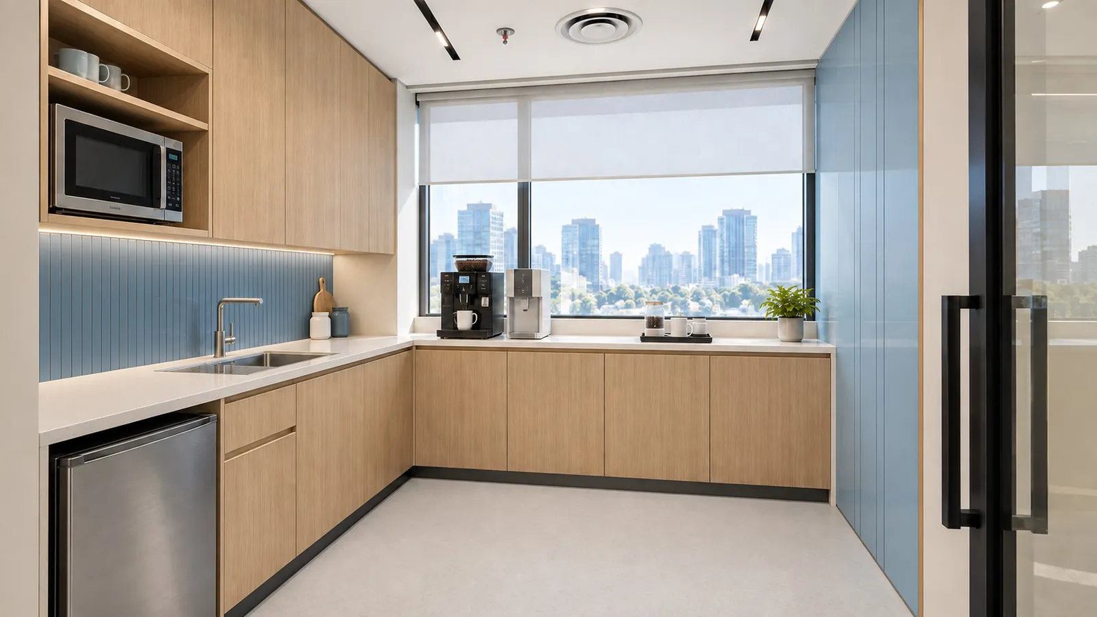 Office pantry with laminate cabinets, a sink run, coffee machine and easy-clean flooring