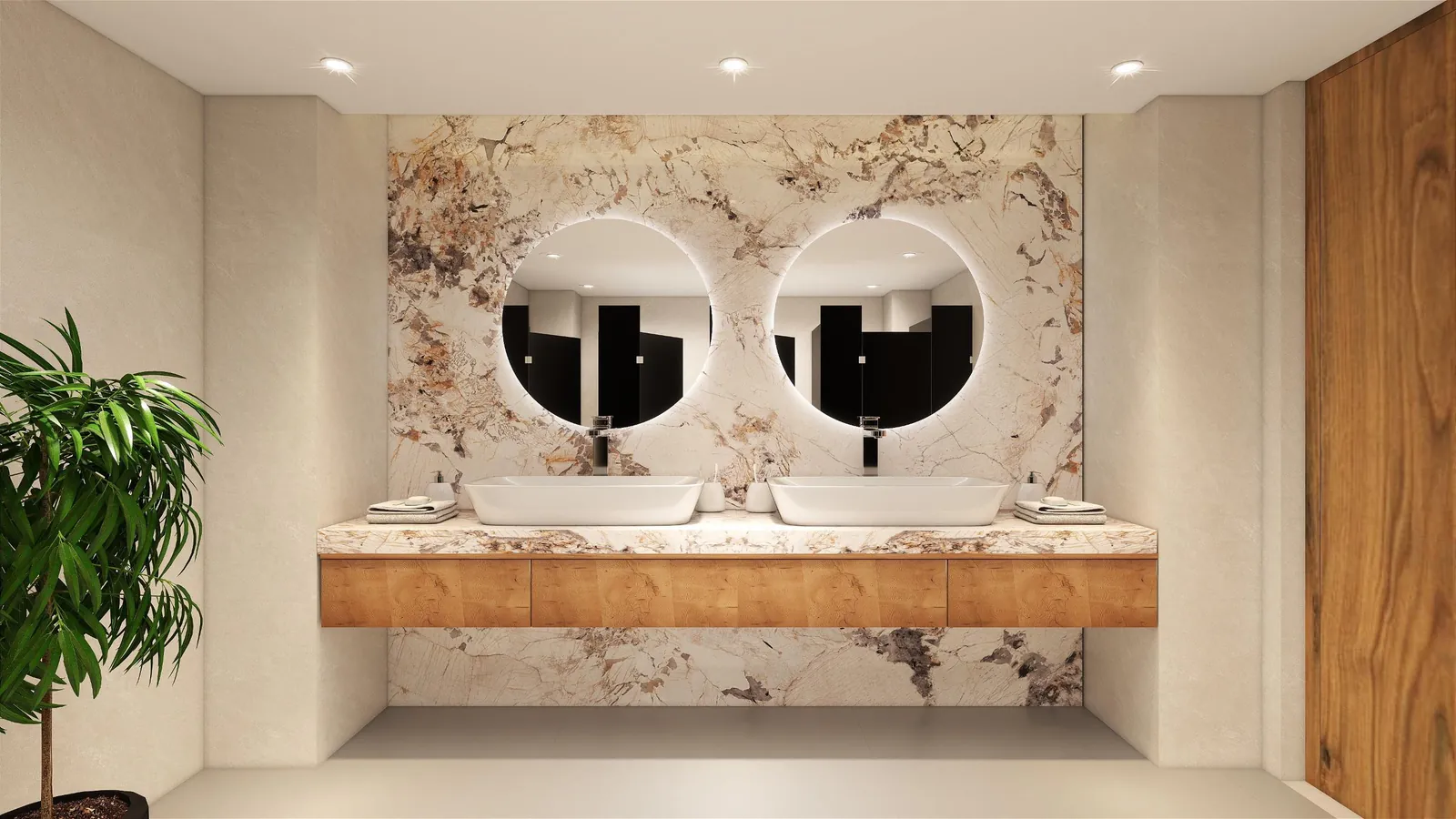 Office washroom with twin basins, round backlit mirrors and a marble wall
