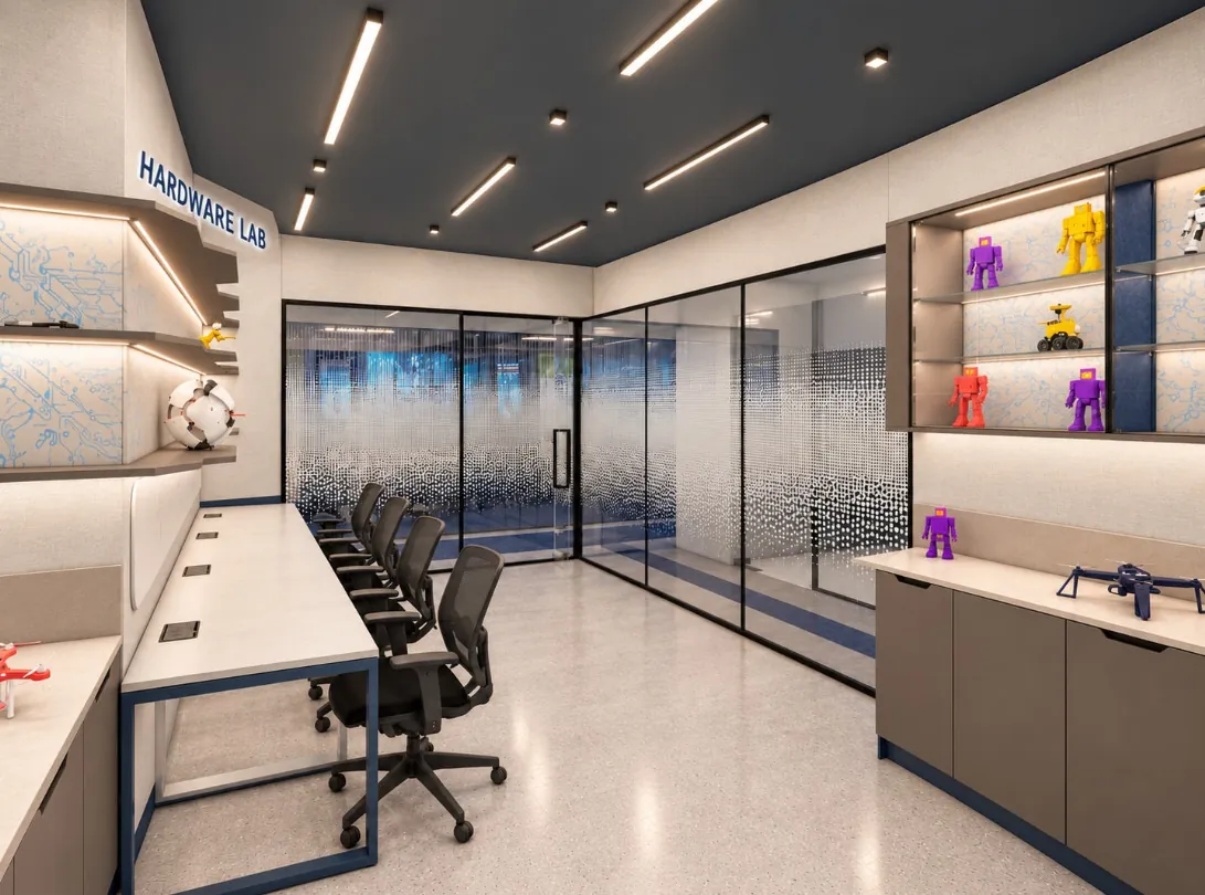 Hardware lab with a charcoal ceiling, linear lights, a long white bench, clay-toned cabinets and printed circuit-pattern panels