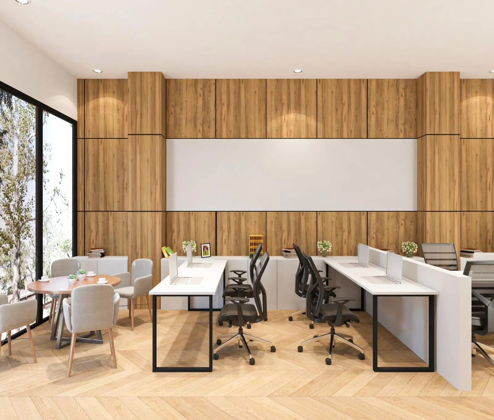 Workstation desks beside full-height glazing with a small meeting table at the window