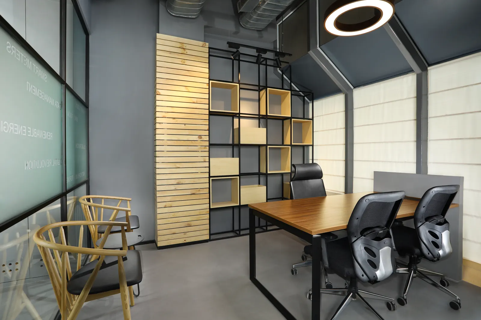 EDF International glass-walled cabin with timber and black-metal shelving and a circular pendant light