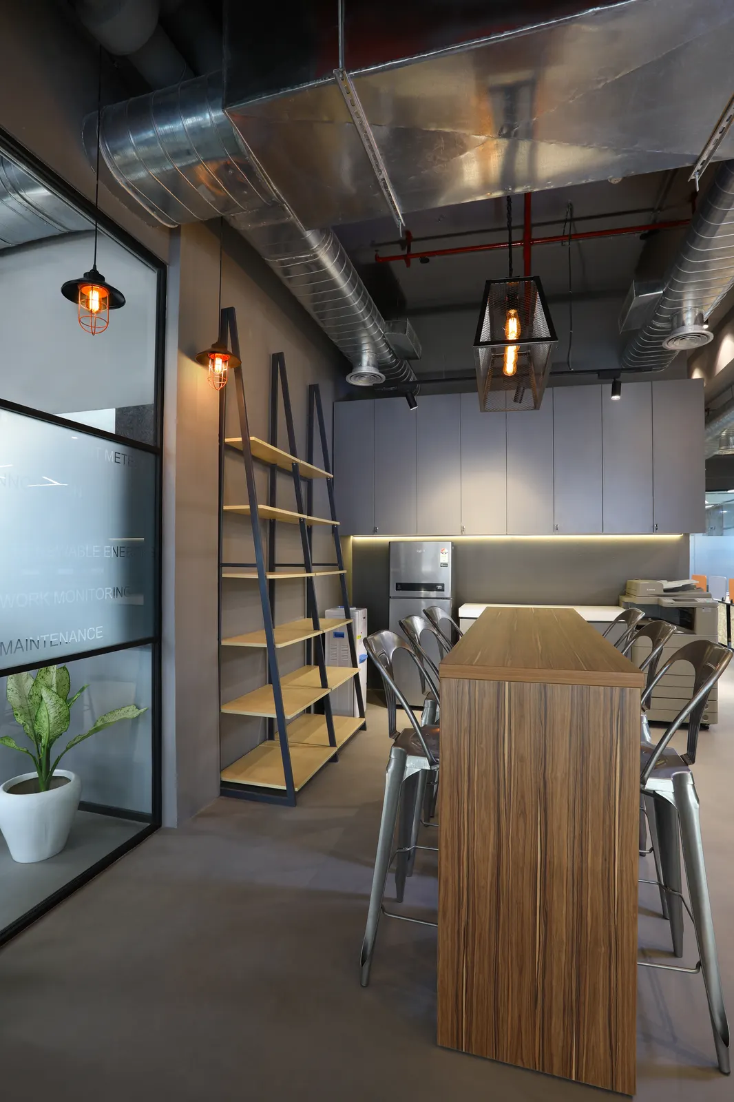 EDF International pantry with black-metal ladder shelving and cage pendant lights