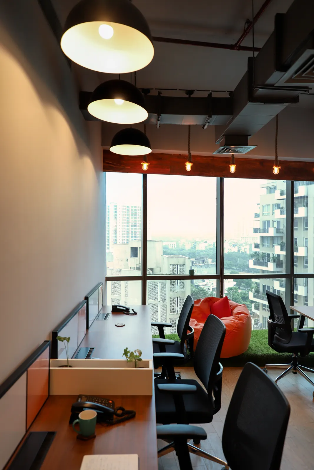 Hashtag Orange breakout corner with orange bean bags beside floor-to-ceiling windows