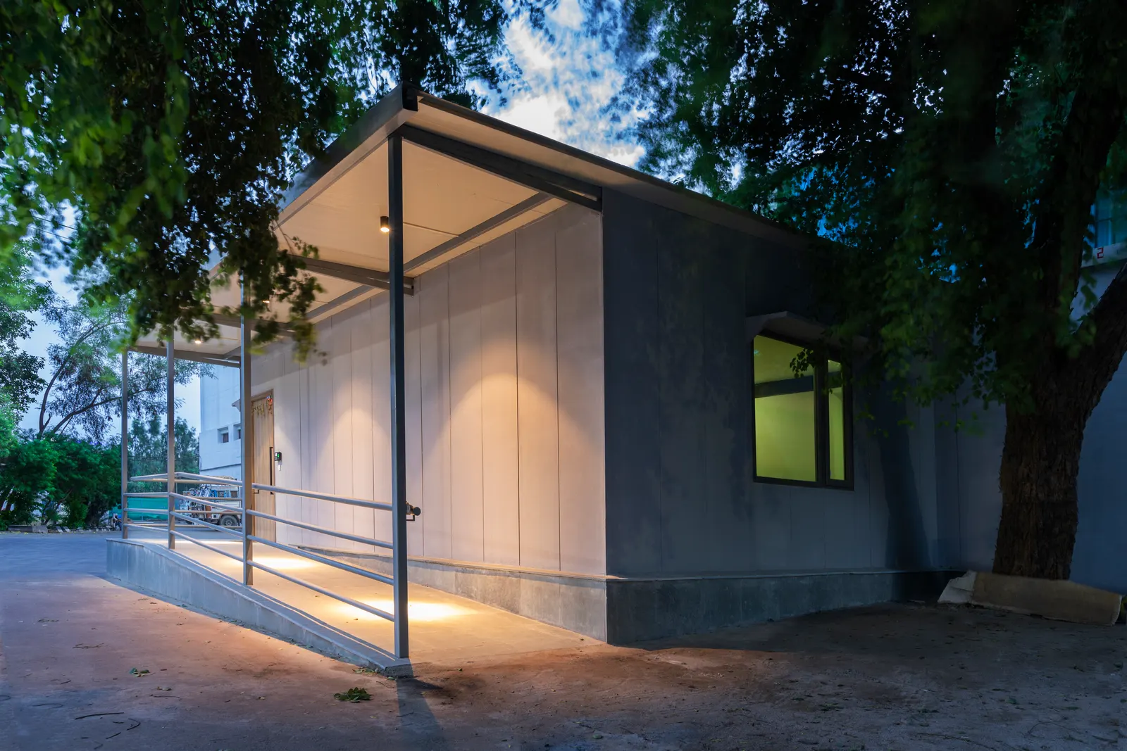 Imperial Malts pre-engineered office building lit at night under the trees