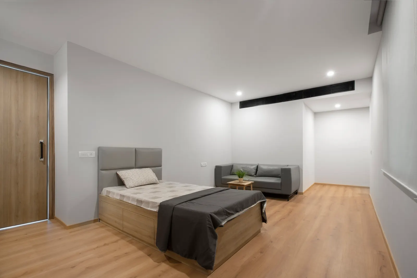 Imperial Malts rest room with a bed, sofa and timber flooring