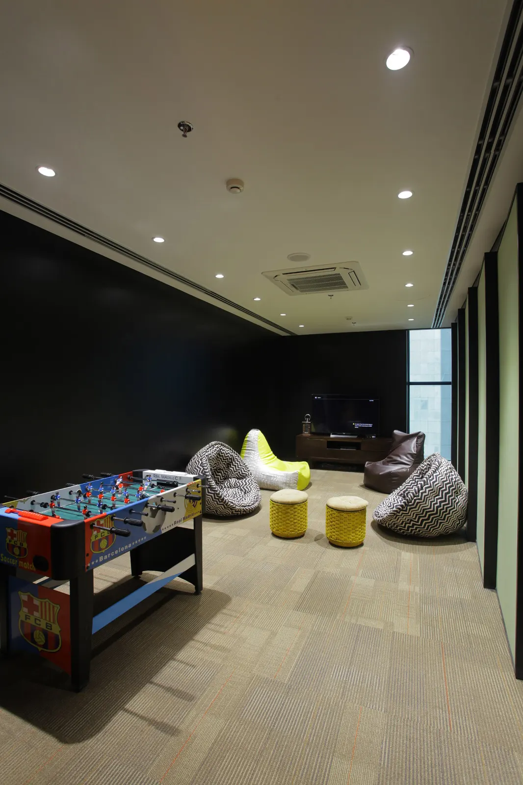 Inshorts Media games room with a foosball table and bean bags