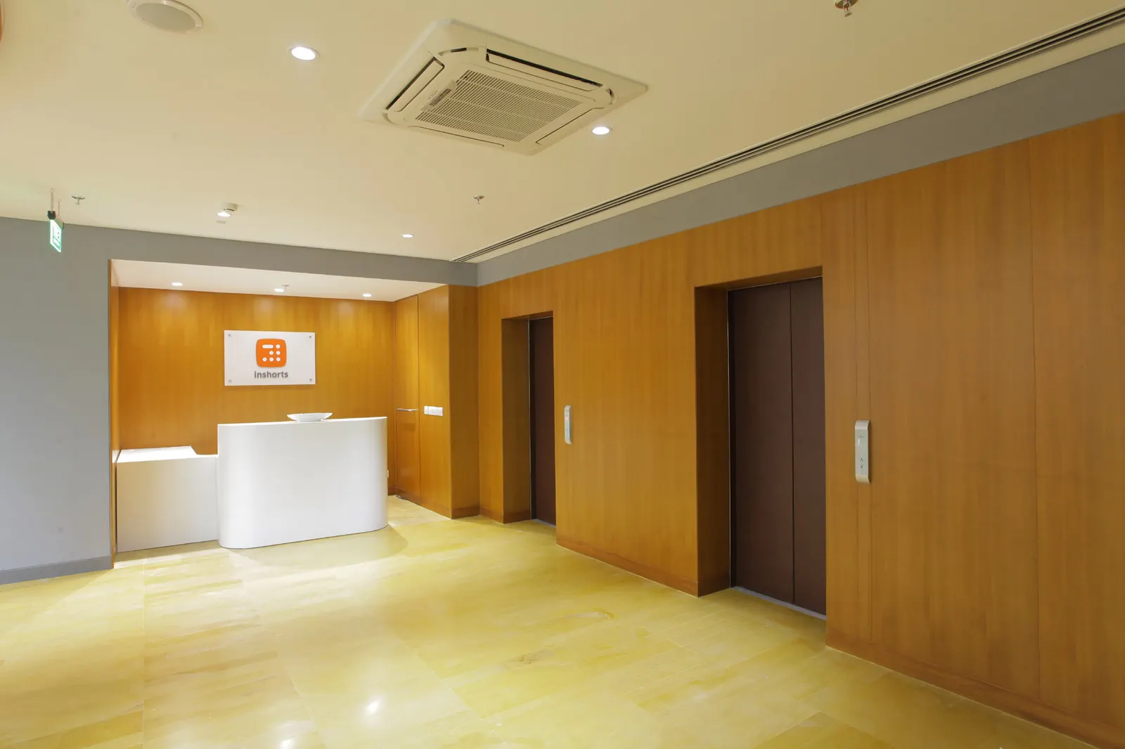 Inshorts Media lift lobby and reception with timber wall panelling