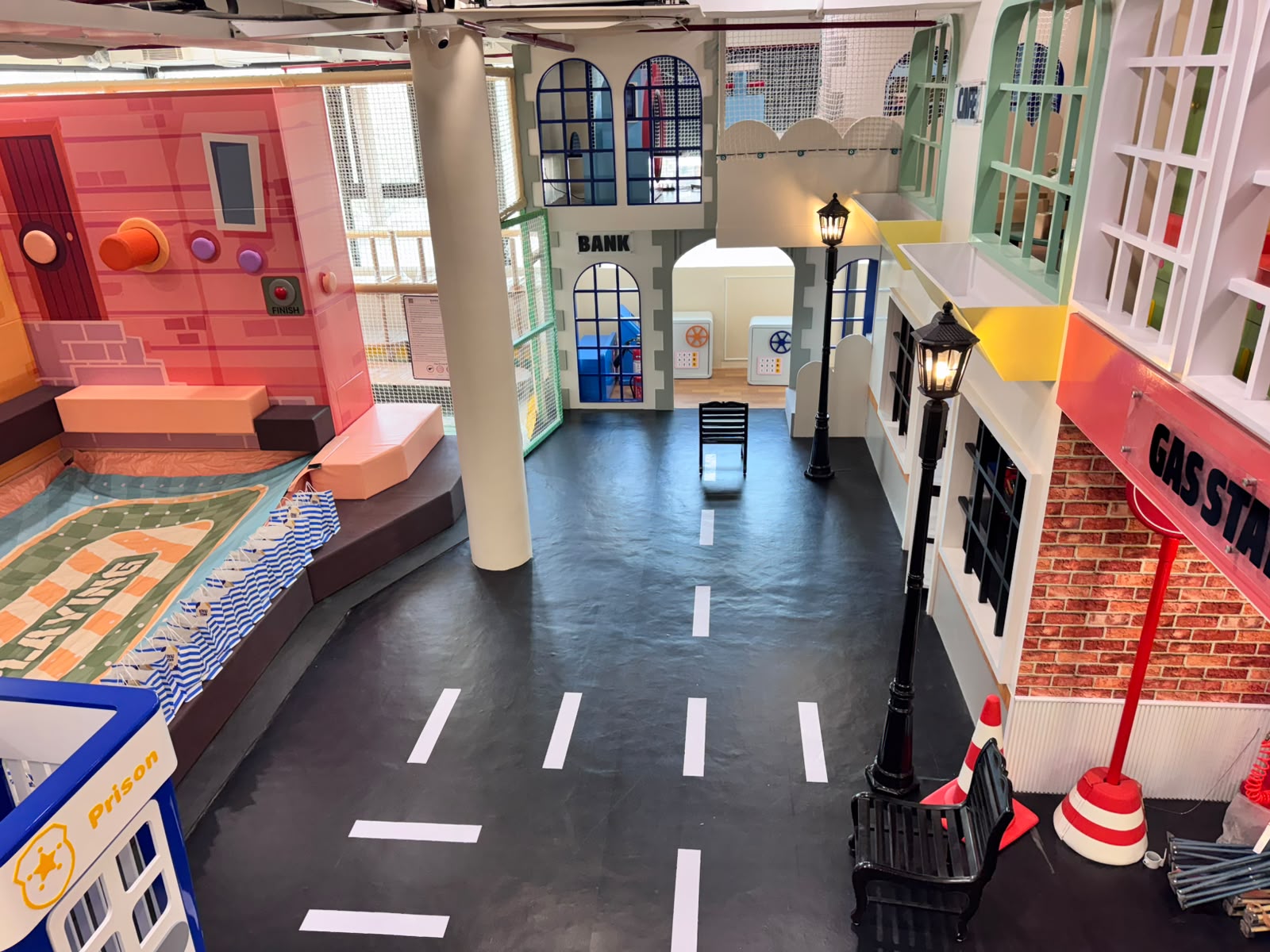 Kokko Town pretend-play town square with Bank and Hospital facades and a Prison role-play booth