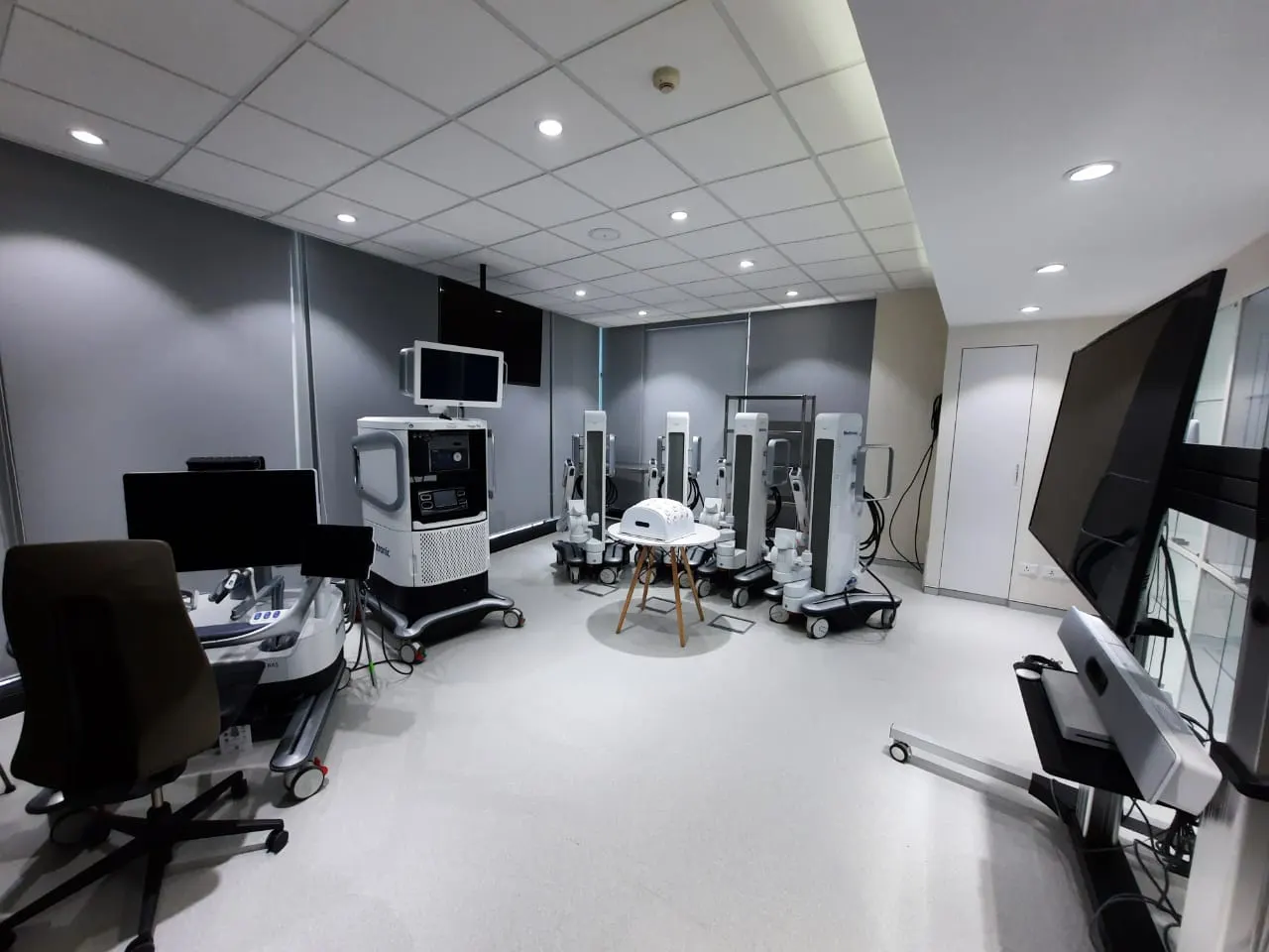 Medtronic training room with a grid ceiling, display screens and equipment stations