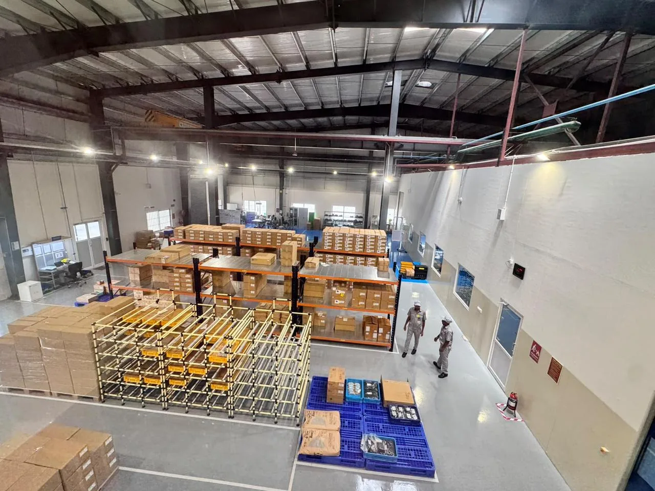 Overhead crane spanning the MinebeaMitsumi warehouse bay above pallet racking