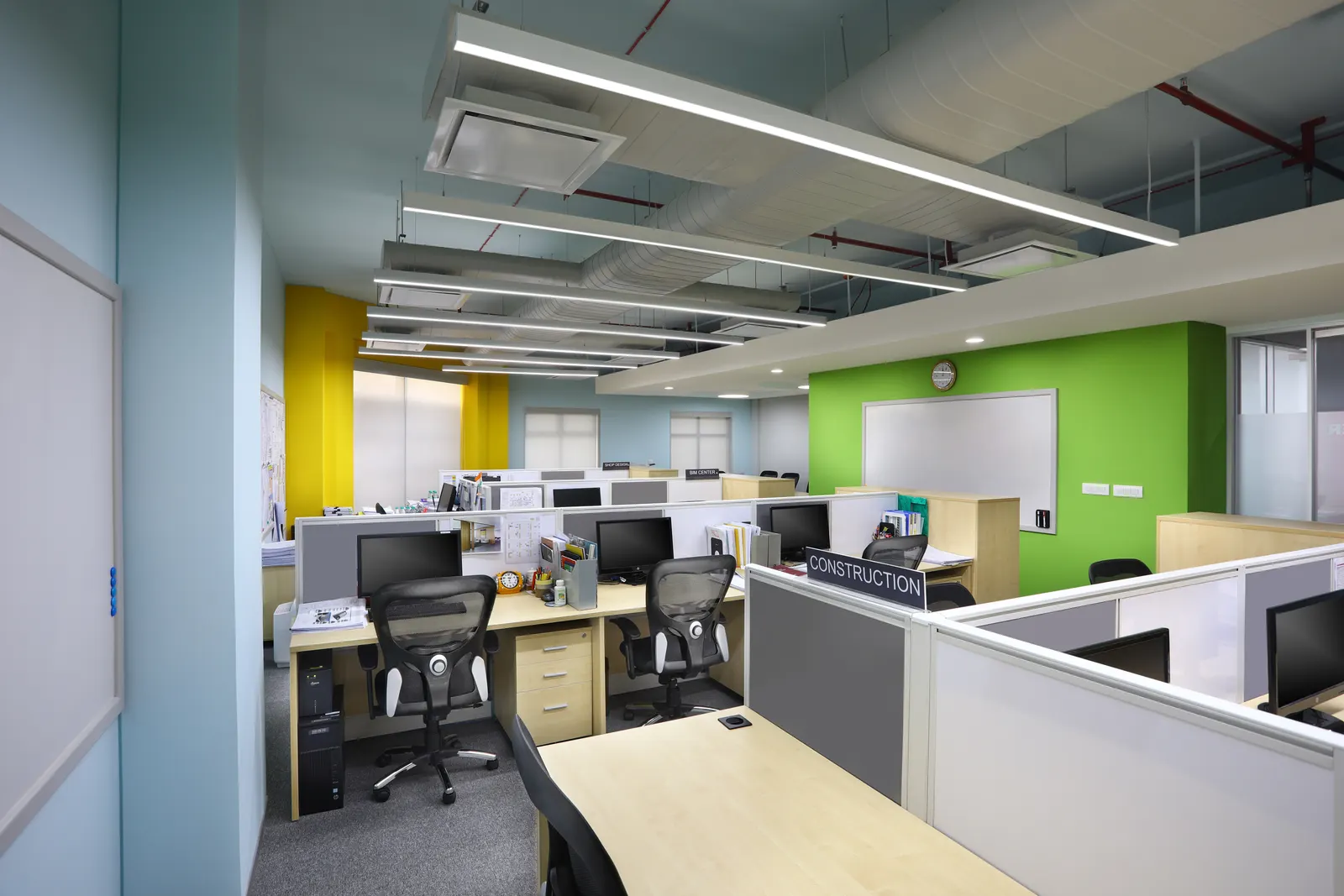 Takenaka open office with yellow curtains, whiteboards and linear lighting