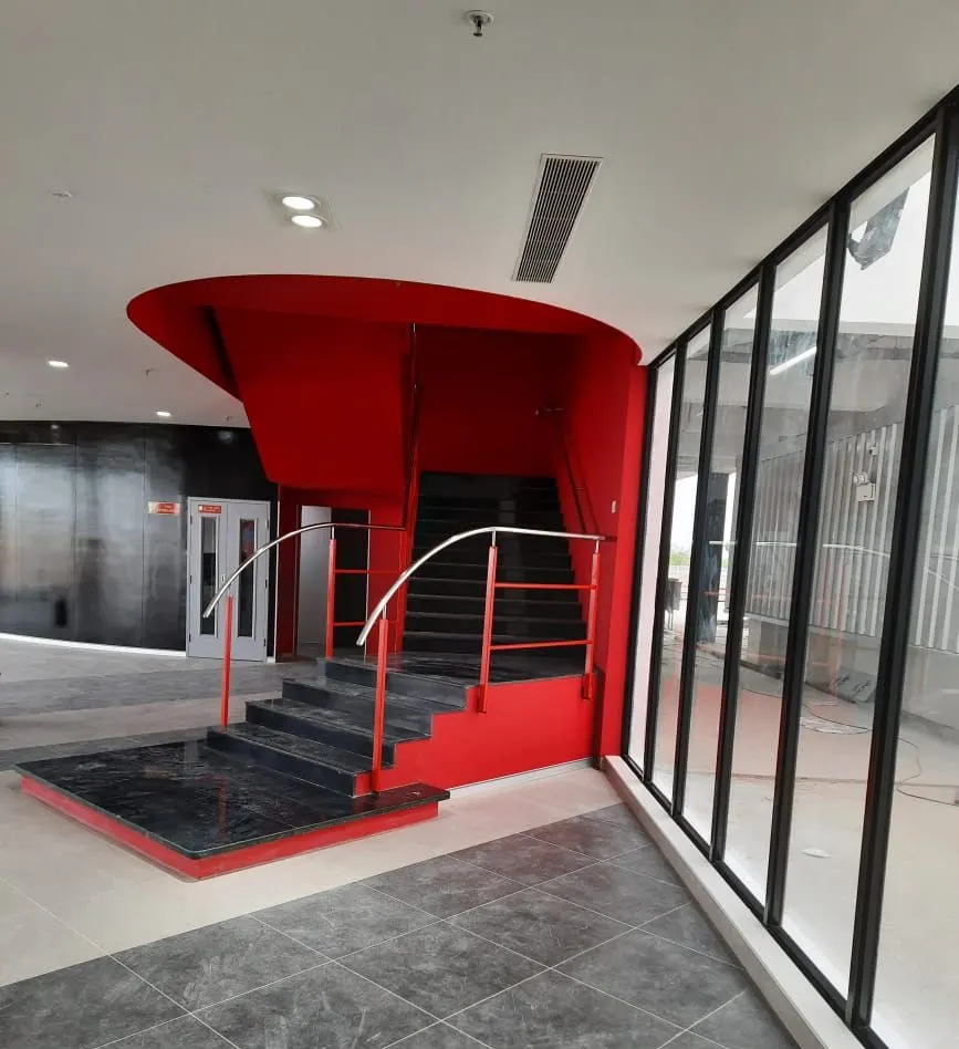 Yanmar factory red feature staircase with black-framed glazing